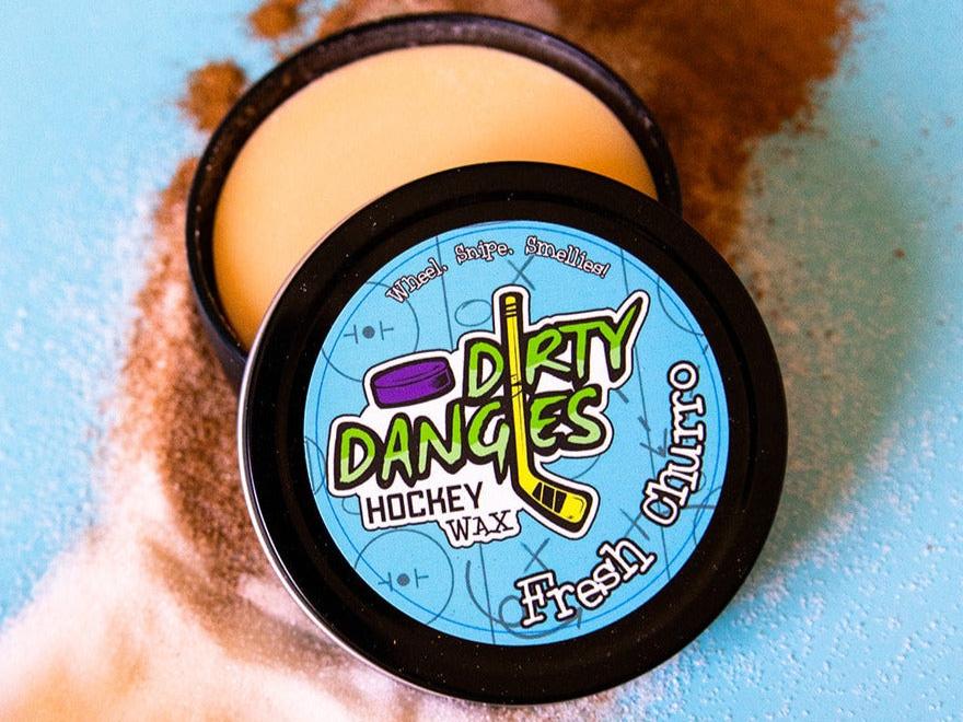 Fresh Churro Scented hockey stick wax on a blue background surrounded by cinnamon and sugar