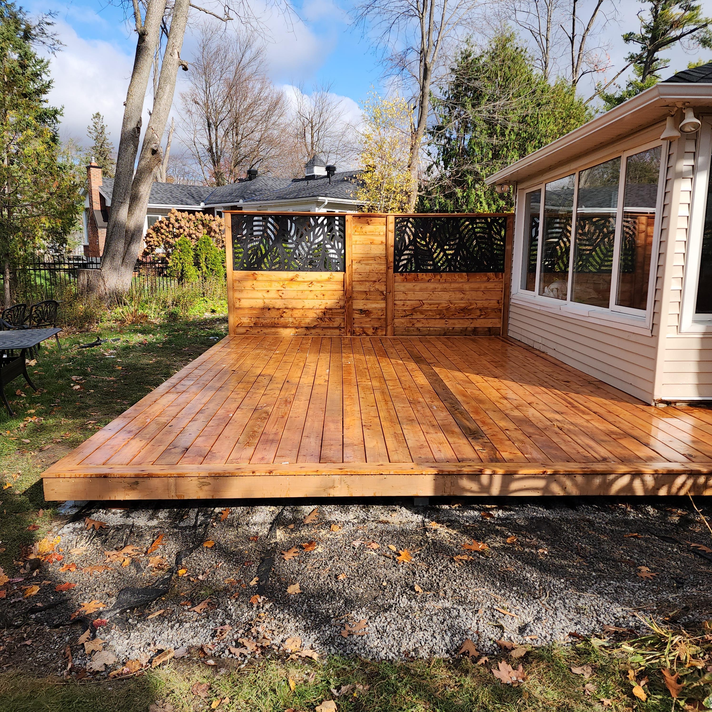Angle of the deck that shows privacy wall straight on. Wall is adorned with metal decorative panels