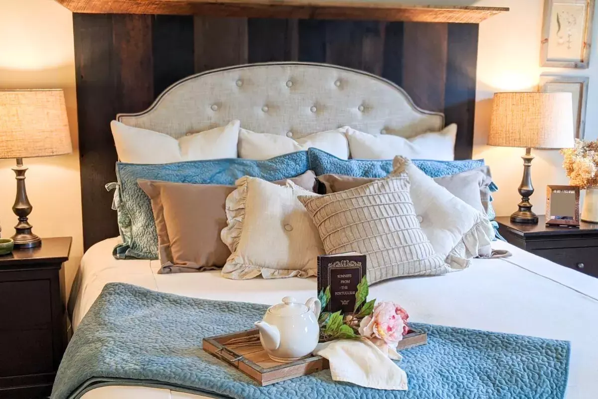 King-size reclaimed wood headboard with upholstered fabric inlay and layered pillows, designed in collaboration with a local interior designer.