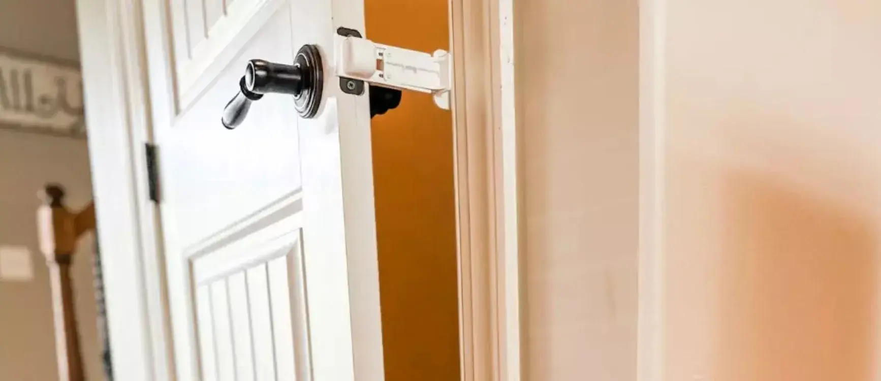 Door Buddy Cat Door Prop installed on a door frame, holding the door open just enough for a cat — no cutting or drilling