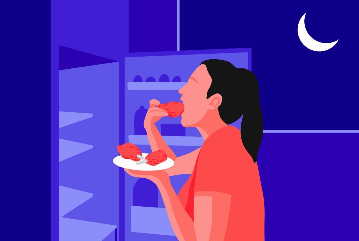 A woman in front of an open refrigerator having a midnight snack of fried chicken, an example of what not to eat before bedtime.