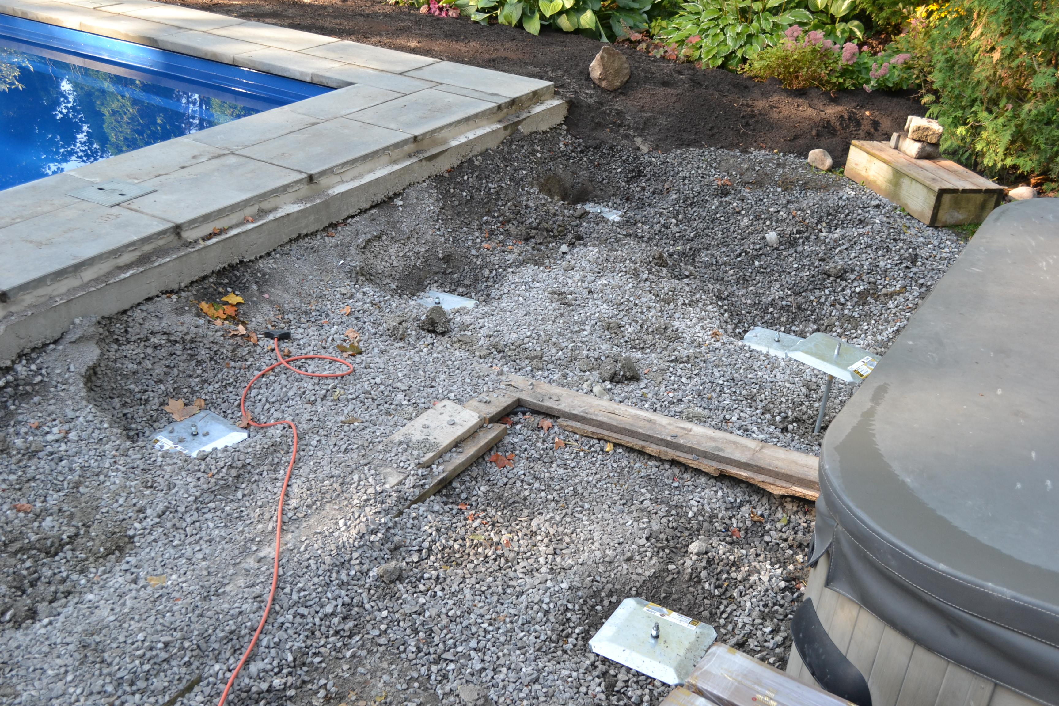 close up of deck foot anchors installed beside the pool