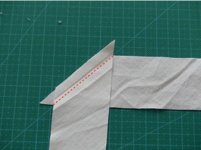 Two fabric strips put together at a 90 degree angle with a dotted line showing the sew line