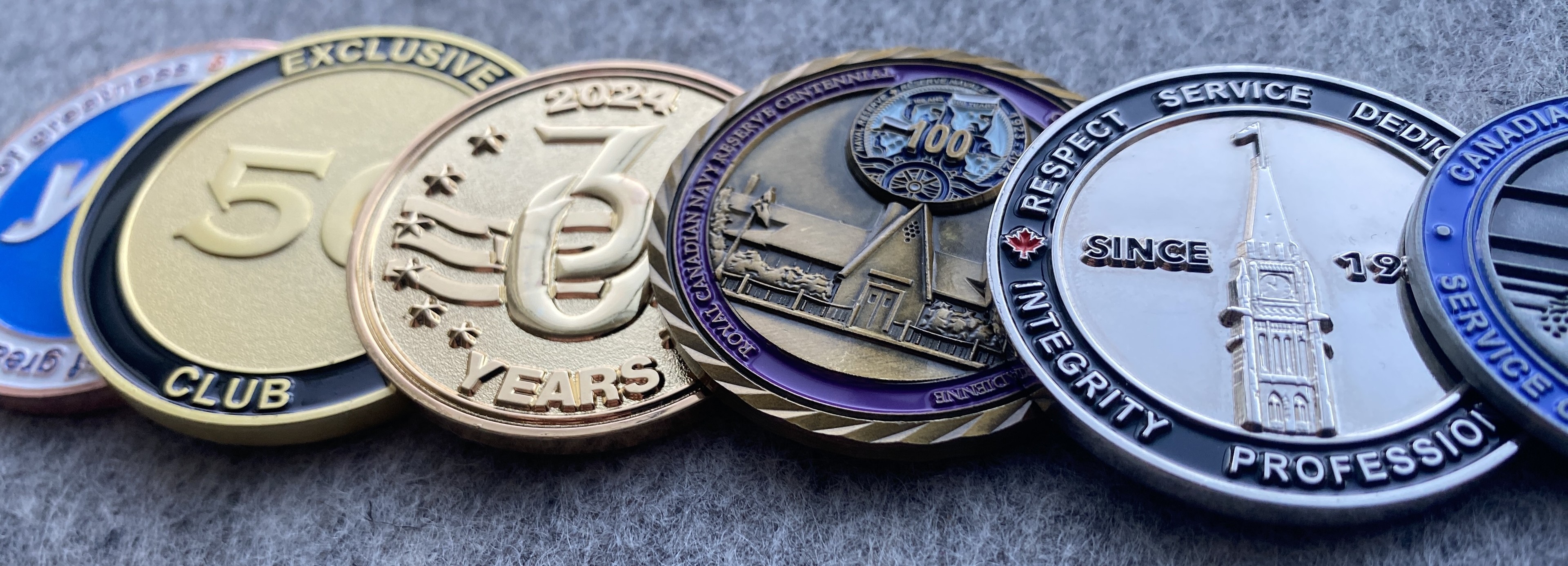 a line of custom made challenge coins with numbers