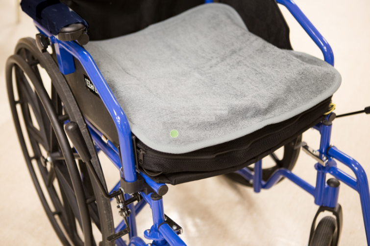 PeapodMat - washable bed mat protecting a wheelchair. 100% leakproof.