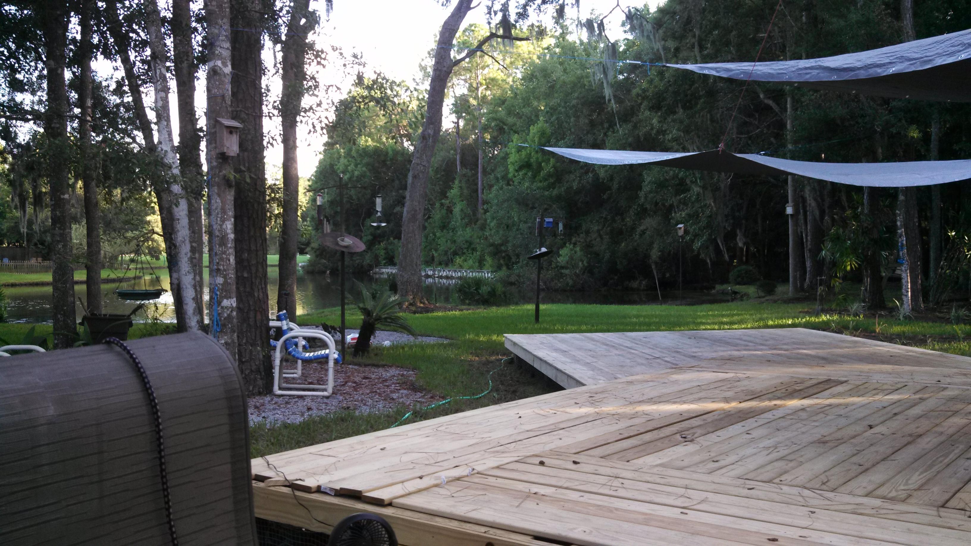 Jim's deck surrounded by a beautiful backyard