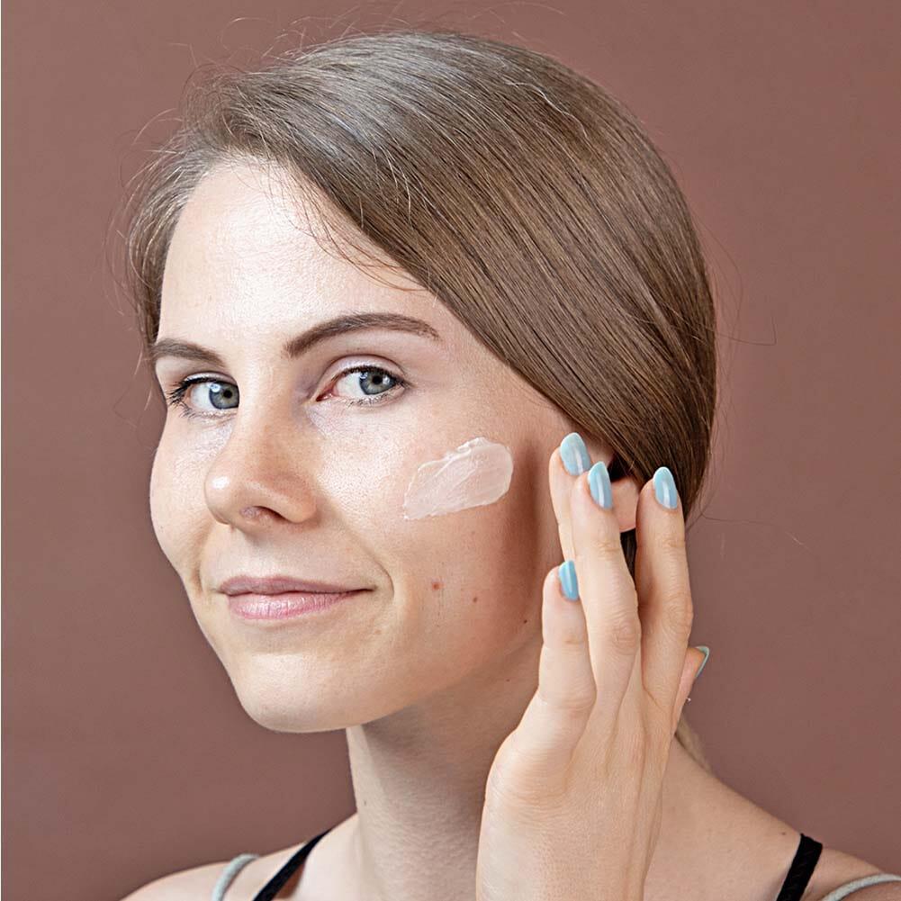 Woman applying Cerabuid cream on face mobile