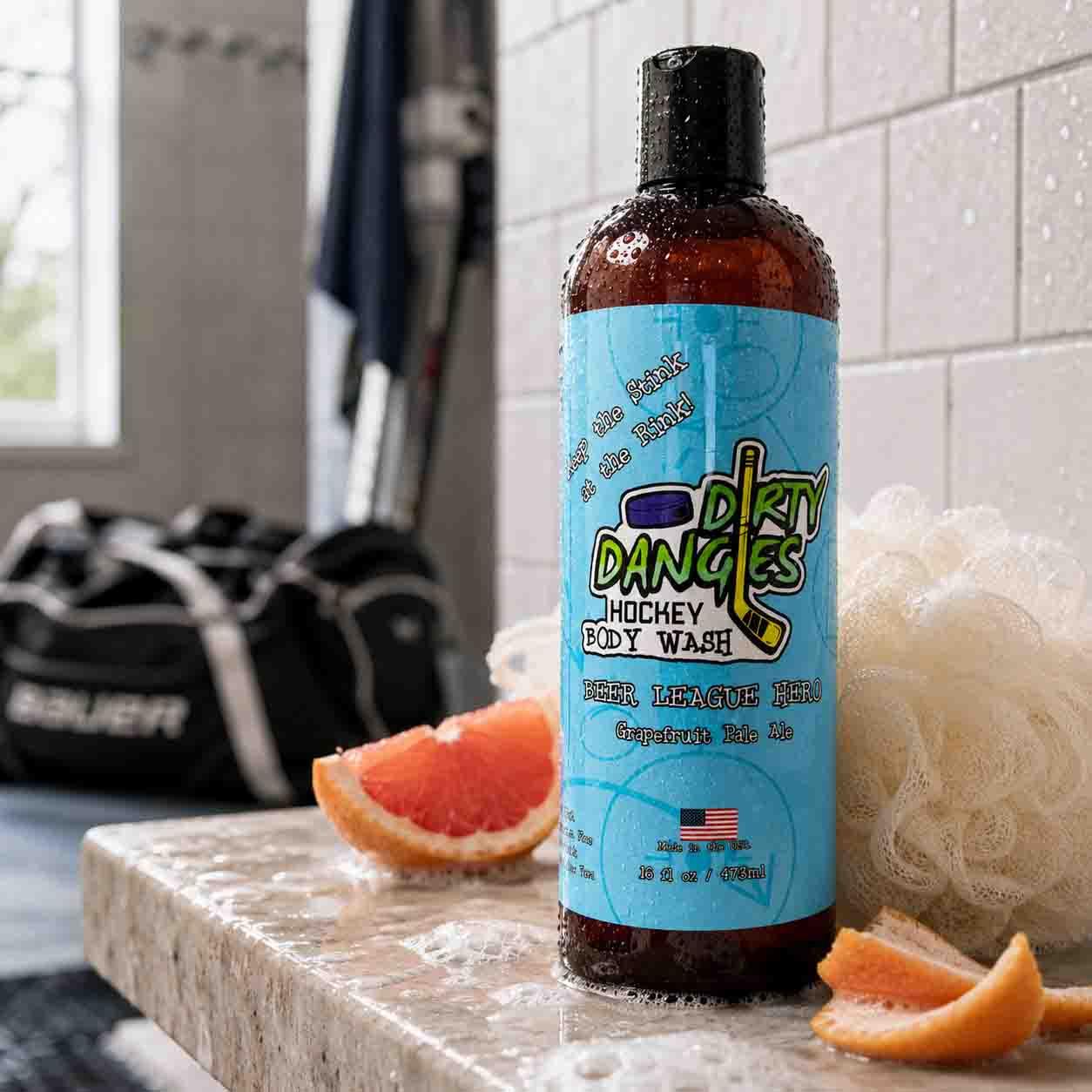 Beer league hero adult Hockey Body Wash inside a locker room with grapefruit and a shower in the background.