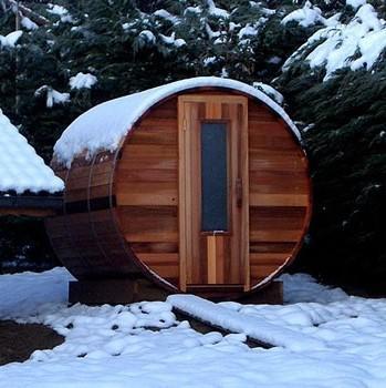 Image of a barrel sauna, which is an outdoor home sauna, in the snow