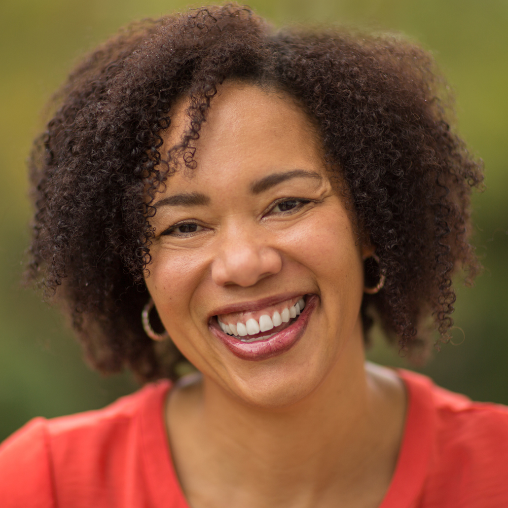 Black woman with curly hair smiling