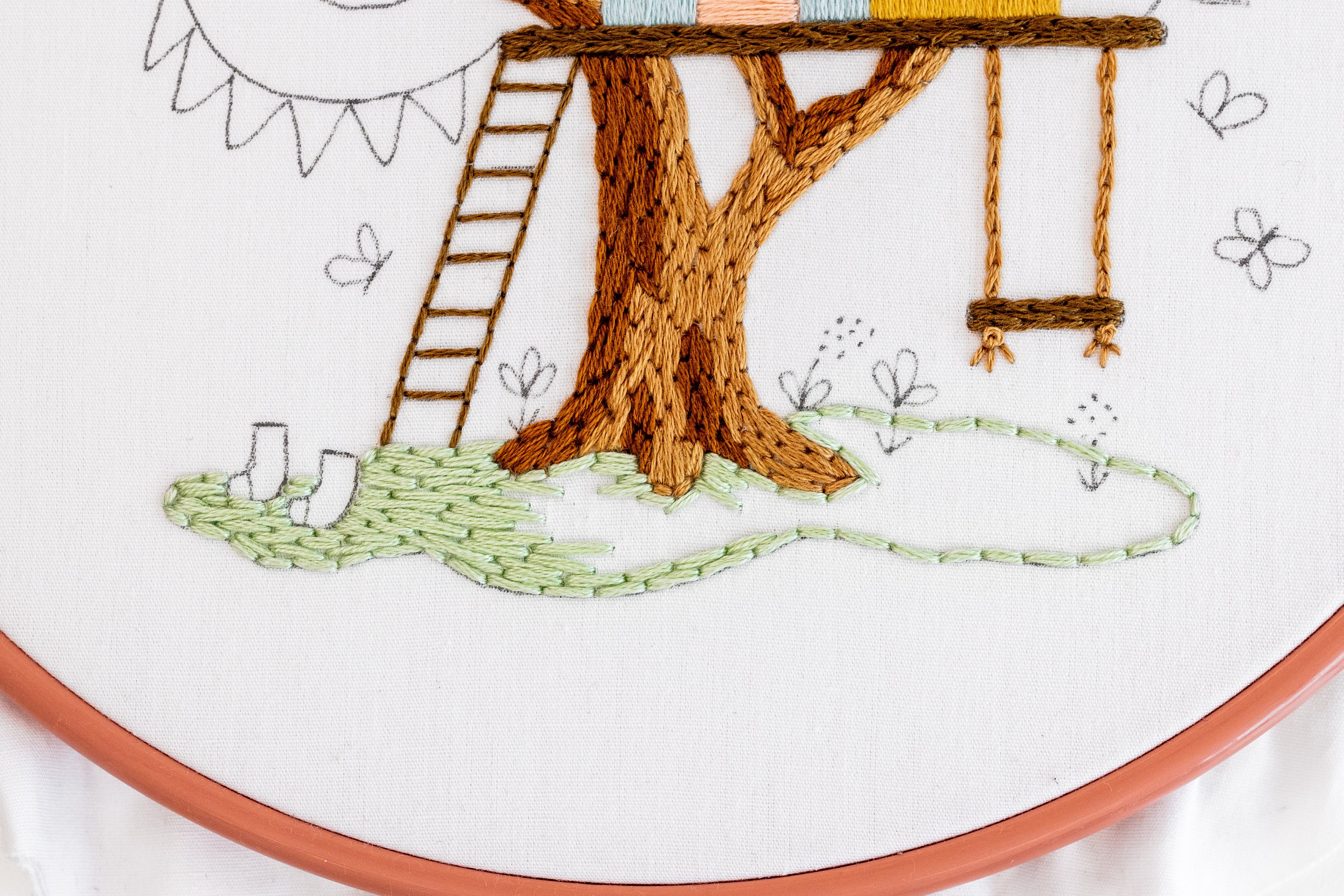 This is an image of a partly stitched grass in The Treehouse pattern by Clever Poppy.