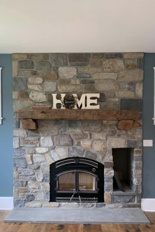 hand hewn mantel with corbels