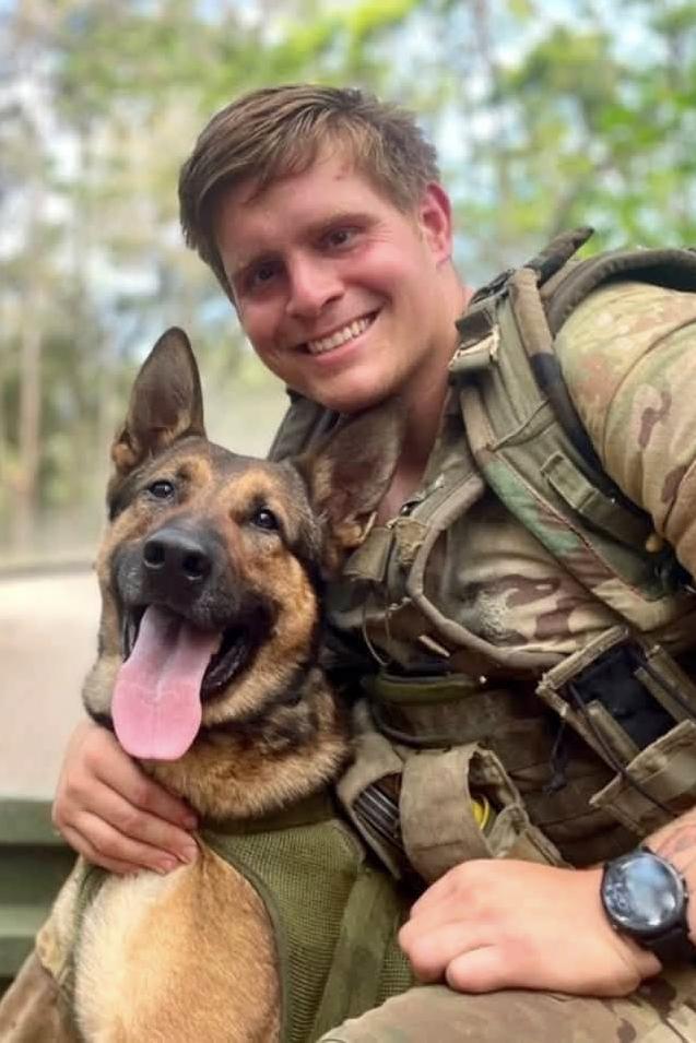 mpc hektor and his handler in a truck bed