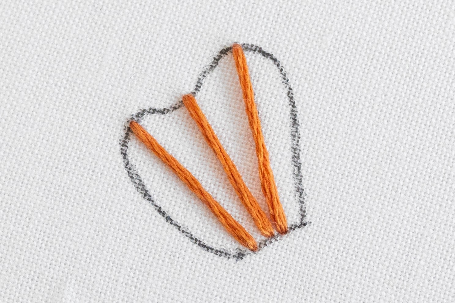A few lines of satin stitch are across the lines on the petal.