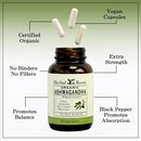 Bottle of Herbal Roots Organic Ashwagandha with three pills spilling out of the top of the bottle. There are several lines pointing to the bottle and the capsules. The lines say Certified Organic, Vegan Capsules, extra strength, No Binders or fillers, Promotes Balance and black pepper promotes absorption