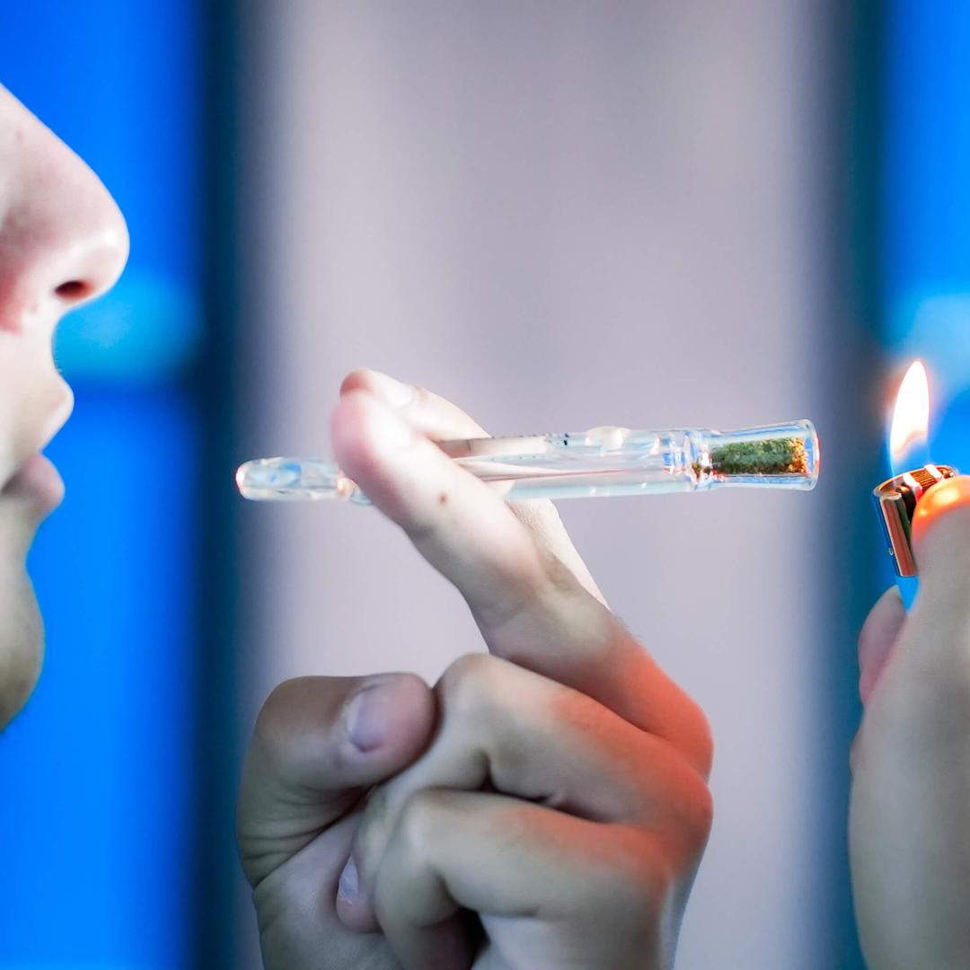 man lighting up one hitter with weed and lighter