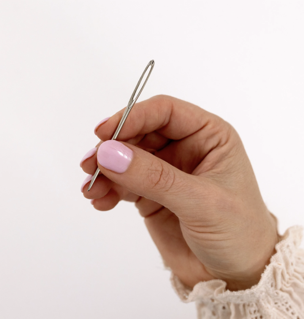 Holding Needle Thread Photos and Images