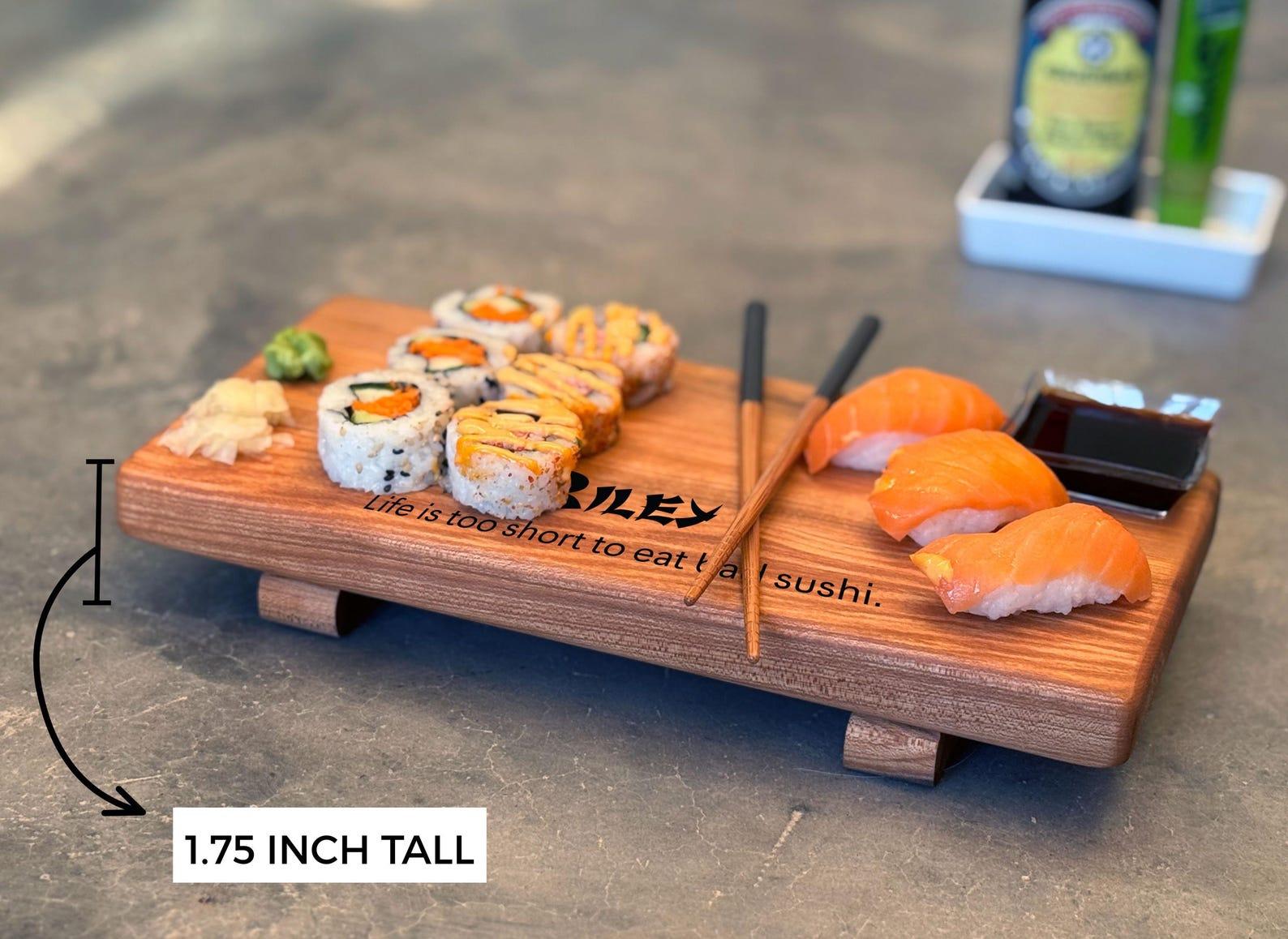 Maple wooden usho plate with food on it and chopsticks, showing it is 1 i3/4 inches high with feet for an elegant elevated look.