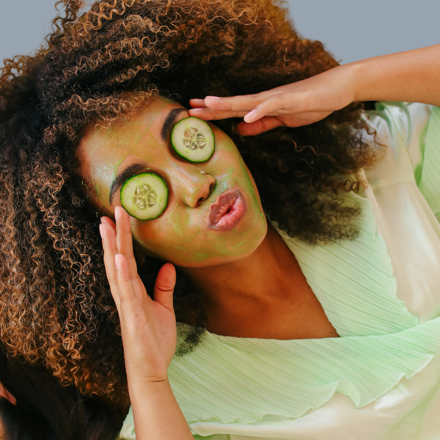 woman treating her dark under eye circles with cucumber