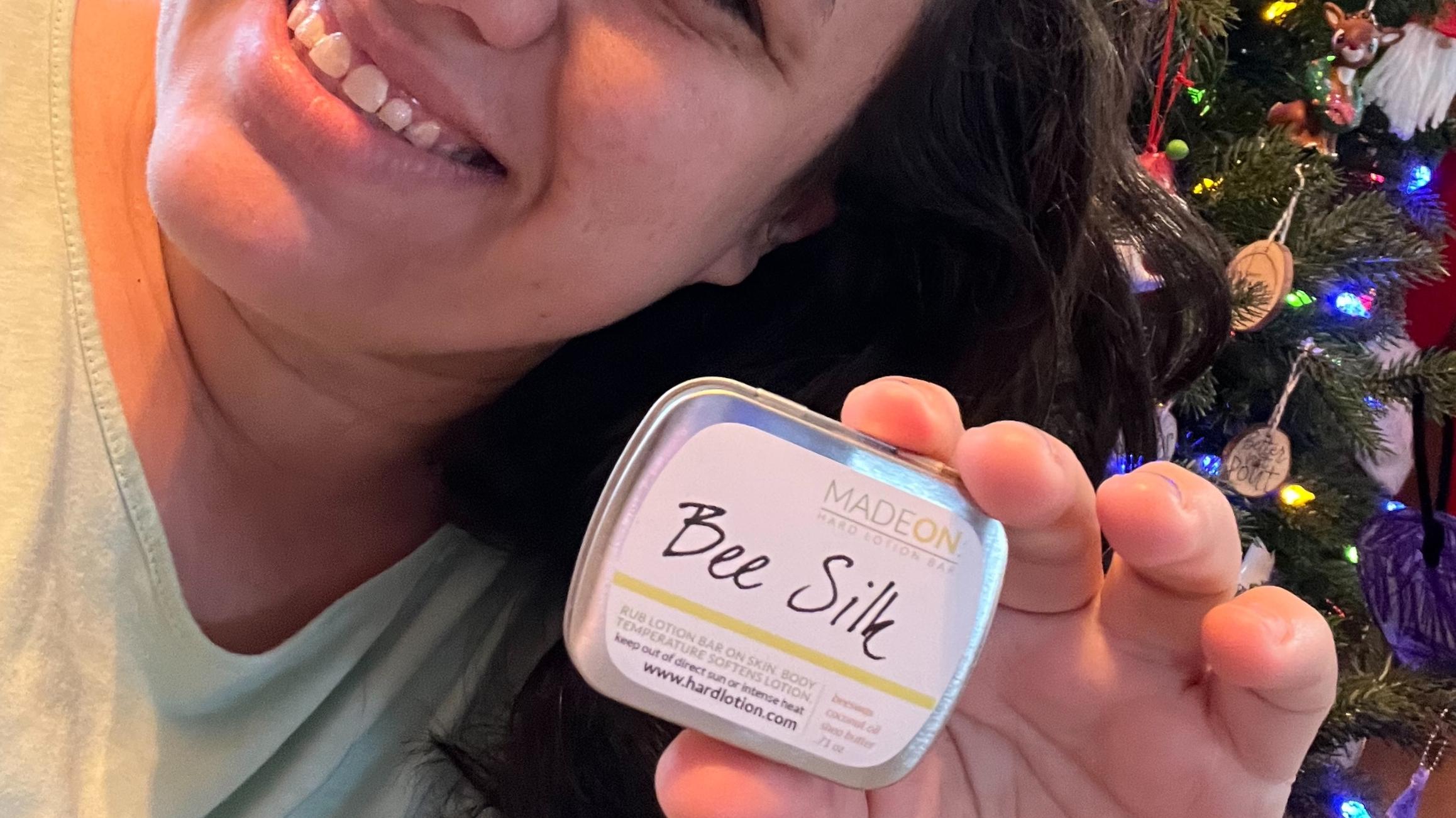 woman holding beesilk lotion bar