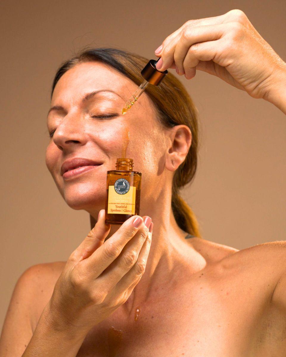 Woman applying Golden Years Face Serum
