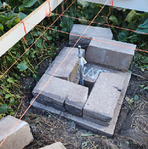 step one drill auger and build paver stones around it