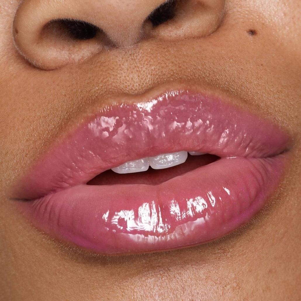 Plumping Lip Gloss - Berry Pout on model lips