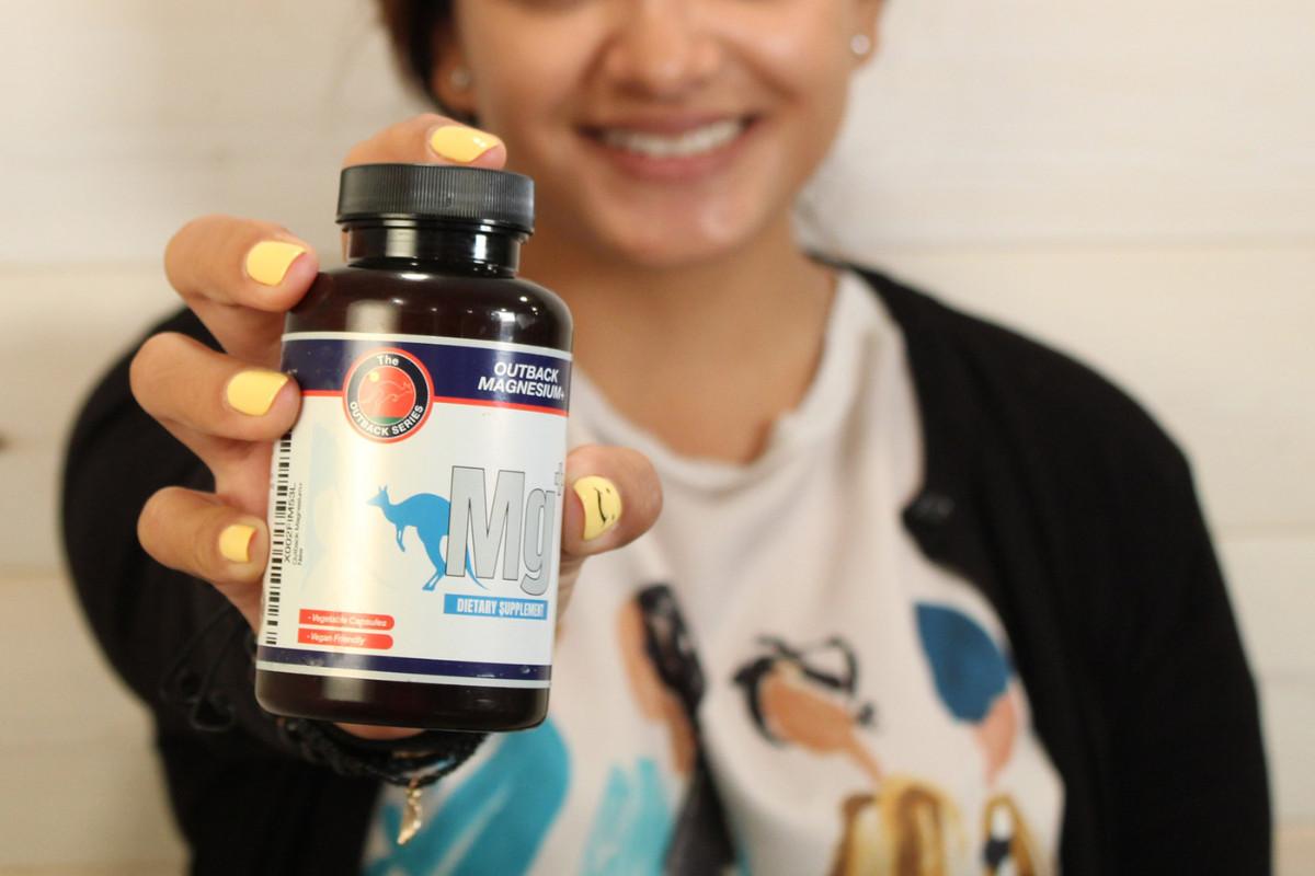 close-up of woman holding Outback Magnesium+