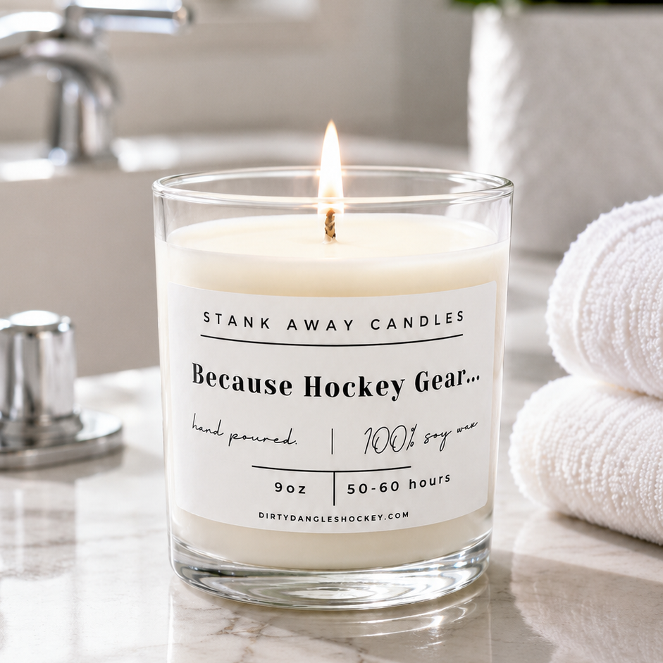 A white scented hockey candle on a bathroom counter. Because Hockey Gear