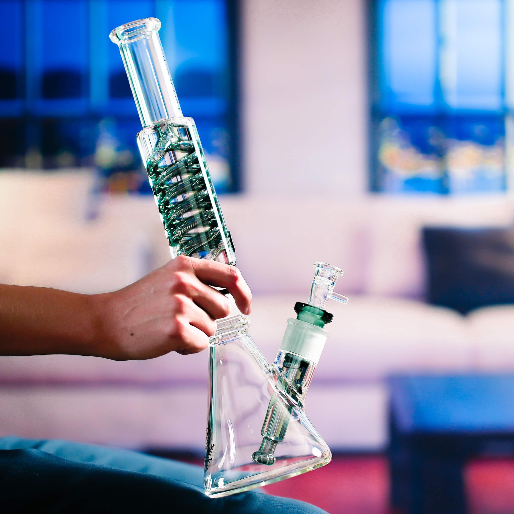 woman holding freeze pipe beaker ultimate on couch