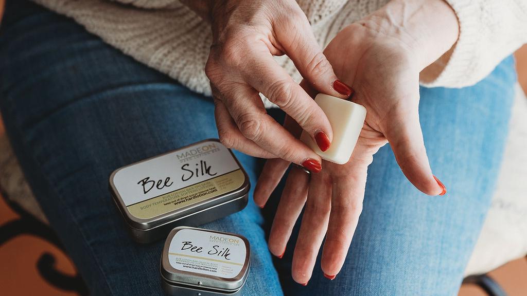 woman holding beesilk lotion bars
