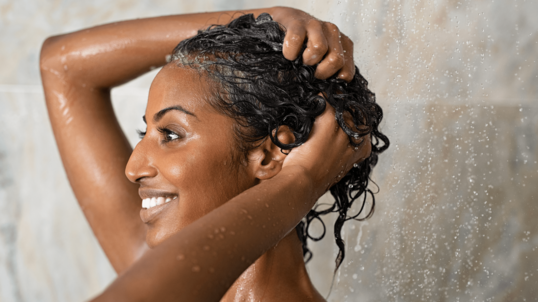 black woman washing her hair in the shower