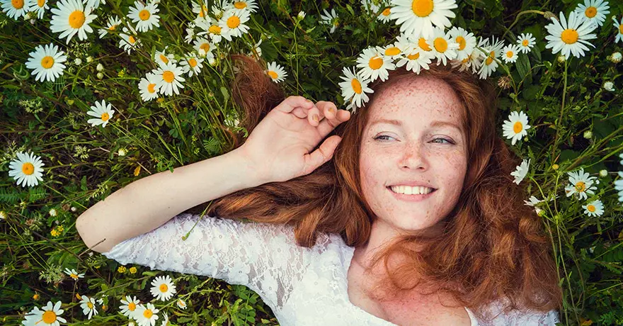 woman laying in flowers with hair down