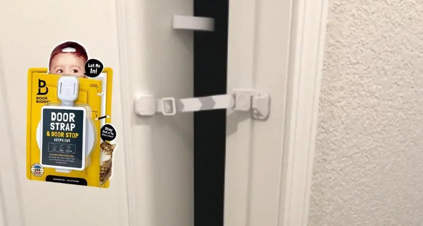 The Door Buddy Adjustable Door Strap is a pet latch and door stopper designed to keep interior doors open wide enough for cats while blocking dogs and toddlers.