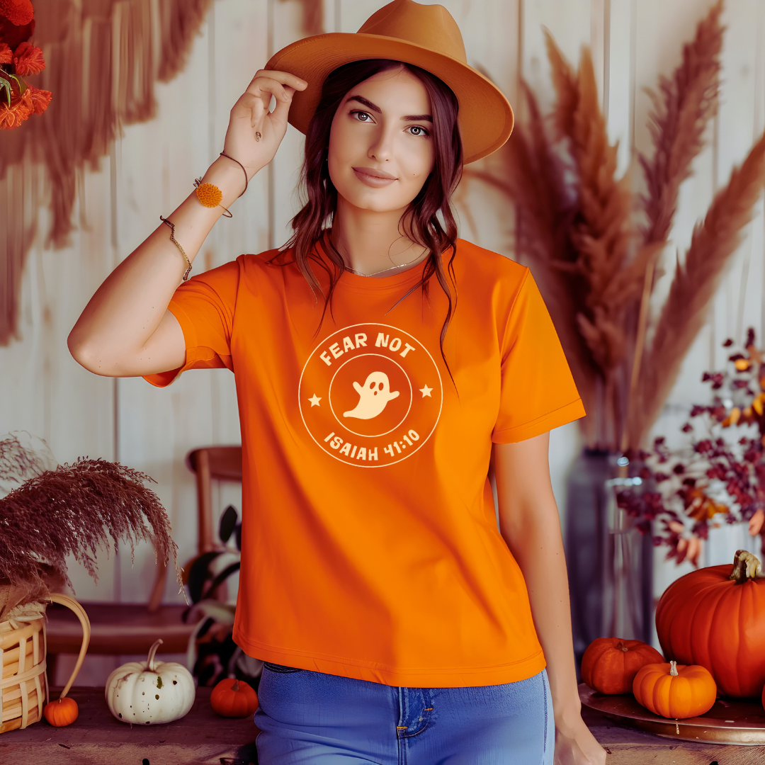 woman in orange shirt with a cute cartoon ghost that says Fear Not Isaiah 41:10