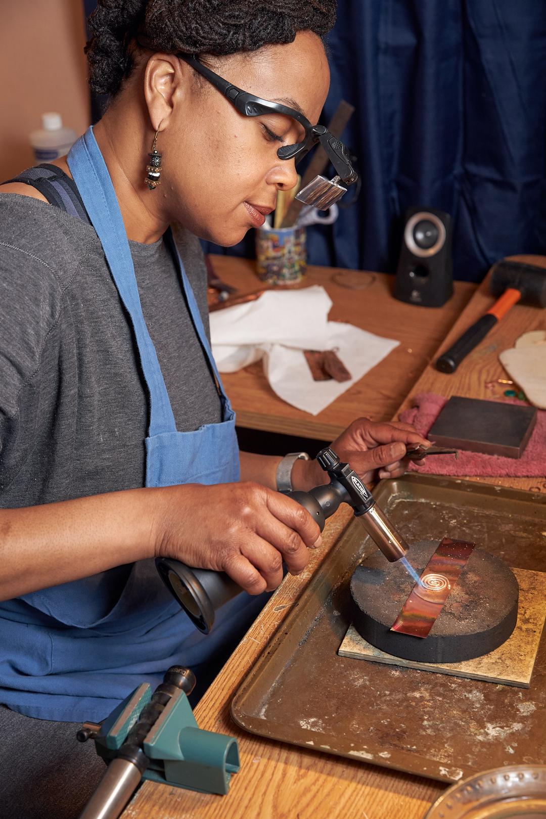 Junebug Jewelry Designs owner Dawn Grady designing a piece of wearable art mixed metal jewelry.