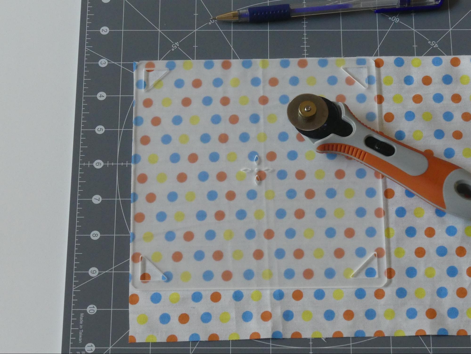 Preparing to cut around a square quilt template.
