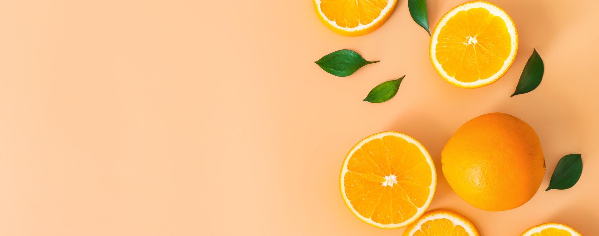 Light orange background with sliced oranges on the right side.