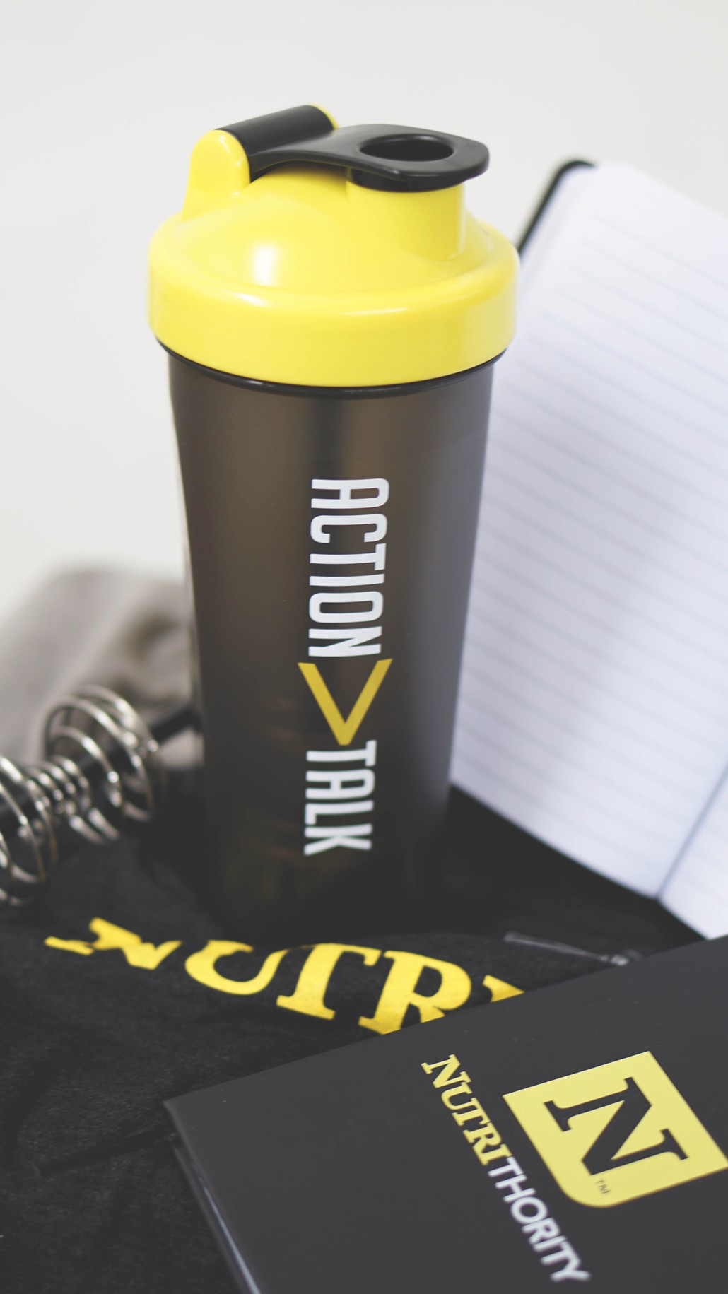 action over talk shaker bottle and notebook