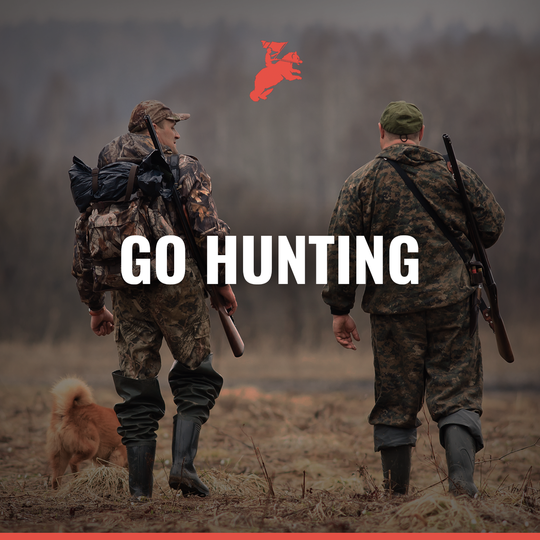 Two men with hunting gear and a dog