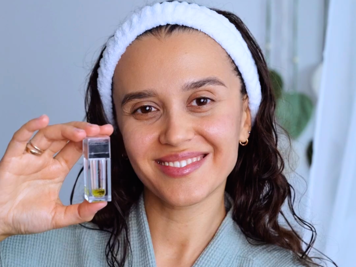 woman smiling holding beautimate hydra stamp