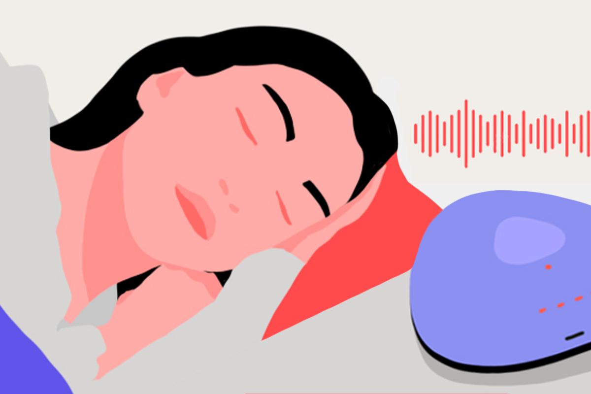 A girl sleeping in bed. There’s a white noise machine on her night table emitting white noise static.