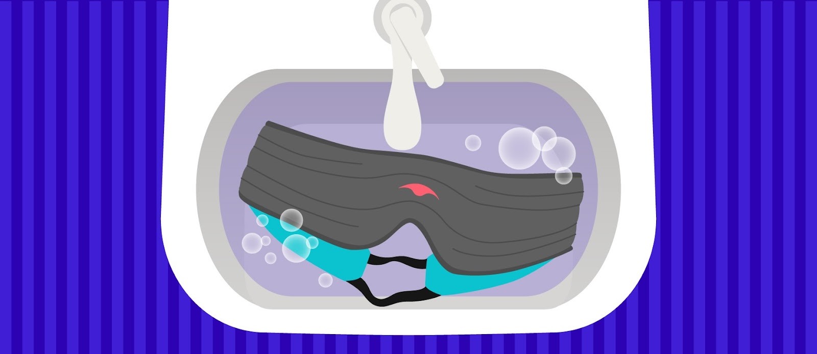 A dark gray weighted eye mask with a green interior, submerged in a sink filled with soapy water.