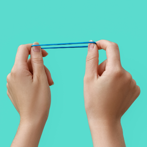two hands stretching a blue rubber band on a teal background