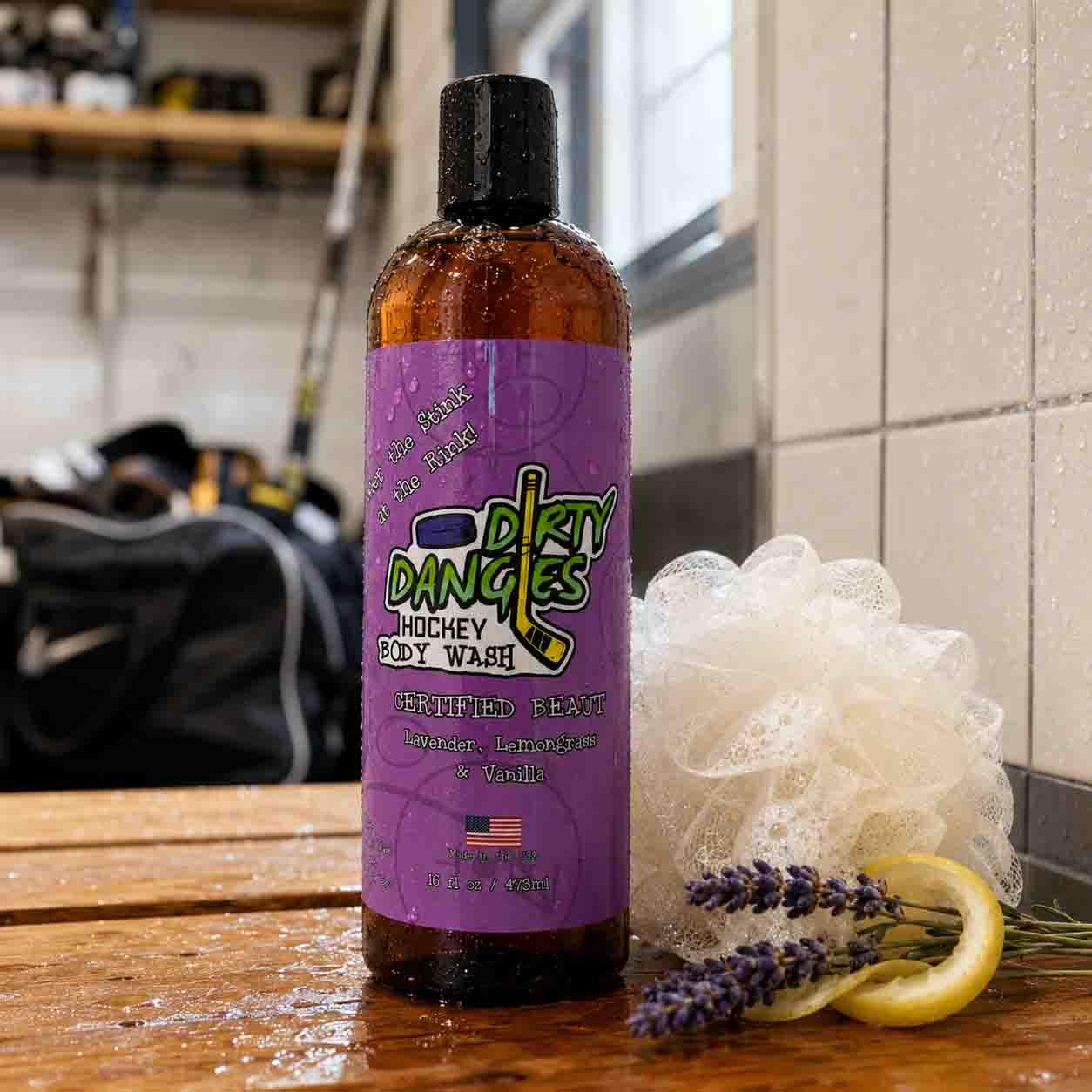 Certified Beaut girl's hockey body wash on a wooden bench inside a locker room with a soapy sponge, lemon and lavender flowers.