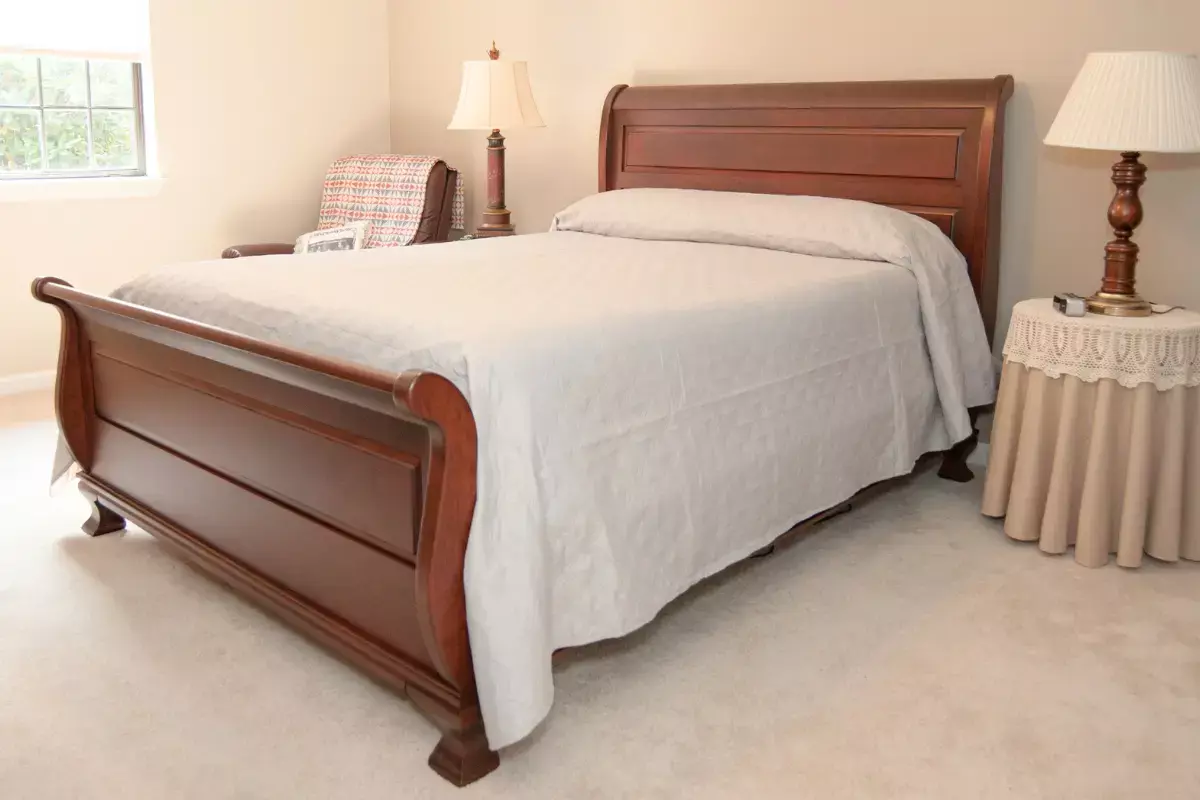 Cherry wood queen-size sleigh bed with traditional curved headboard and footboard, handcrafted for a home in Macungie, PA.