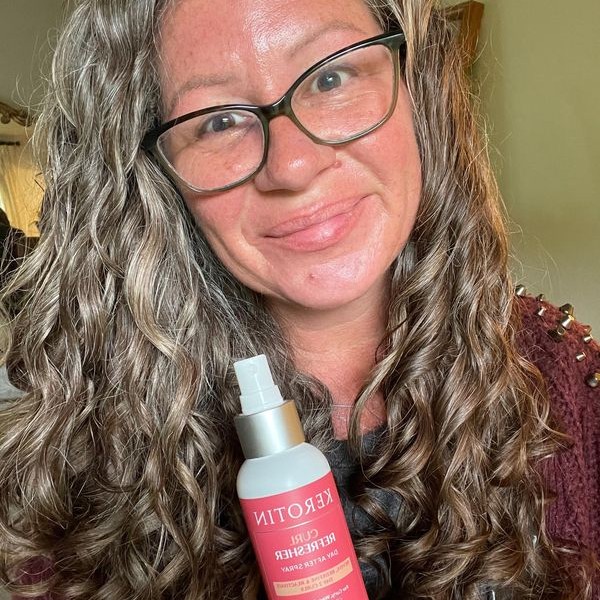 Long curly hair woman with curl refreshing spray
