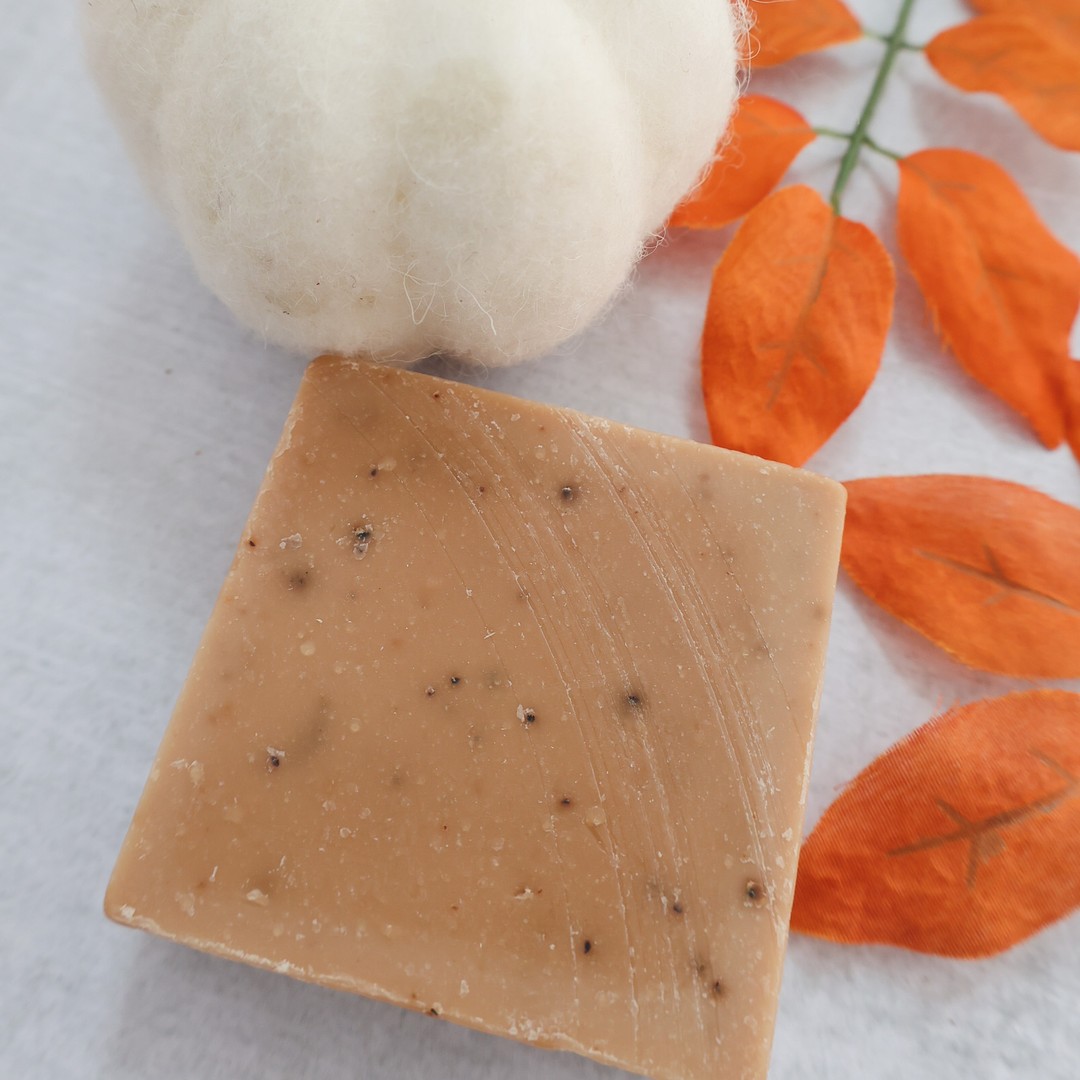 Picture of a bar of Pumpkin Spice Shart Wash Soap on a white background with a white pumpkin and orange leaves