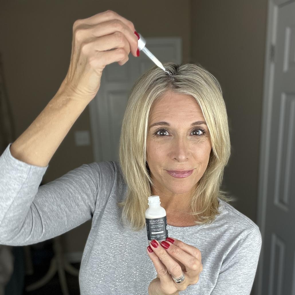 Model With Dark Hair Holding a bottle of Kerotin Hair Vitamins