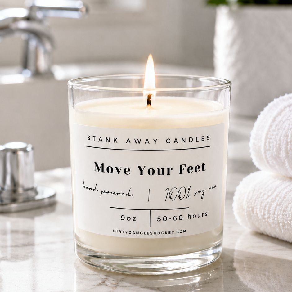 A white scented hockey candle in a bathroom. Move Your Feet